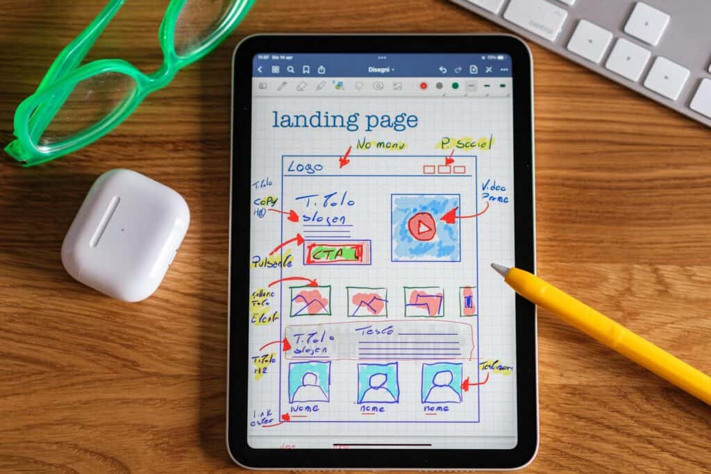 An iPad with the start of a design for a website landing page on it.
