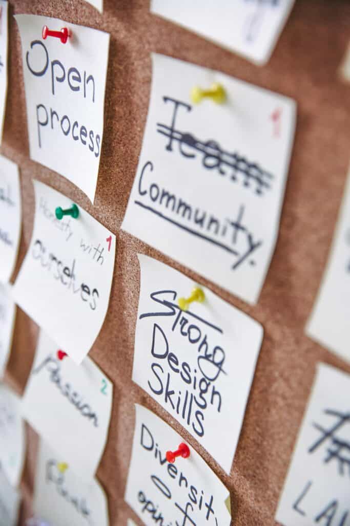 Post-It notes with design project goals written on them.